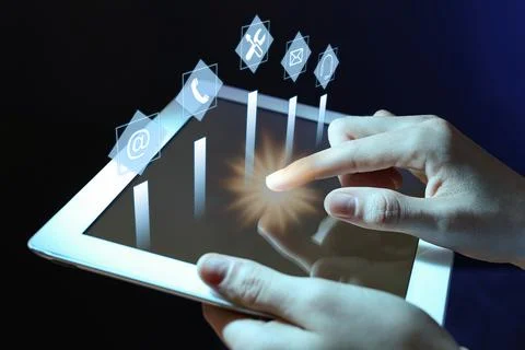 Woman using tablet on dark background, closeup. Technical support 写真素材