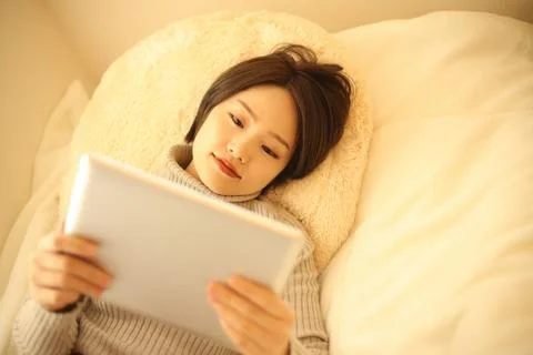 A woman using a tablet device Stock Photos