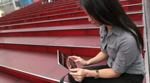 Woman Using Tablet Device on Red Steps - Dynamic Angle Vídeos de archivo 20655439