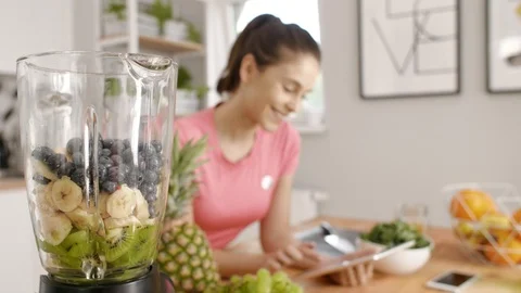 Woman using a tablet during the cooking at kitchen Stock Footage 93339748