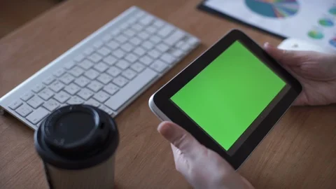 Woman using a tablet with green screen Stock Footage 87031939