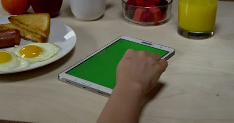 Woman Using Tablet With Green Screen At Breakfast Stock Footage 243286387