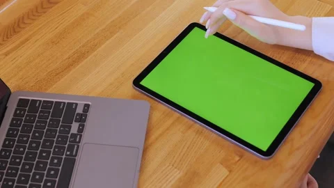 Woman is using a tablet with a green screen Stock Footage 314268168
