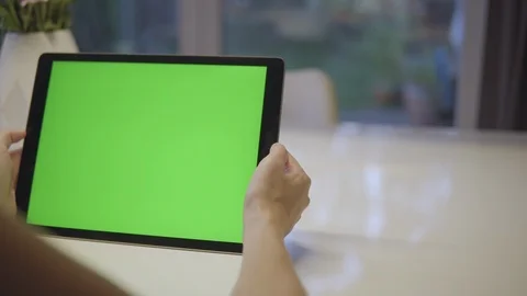 Woman using tablet with Greenscreen Video stock 114497556