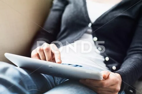 Woman Using a Tablet on Her Lap Stock Photos