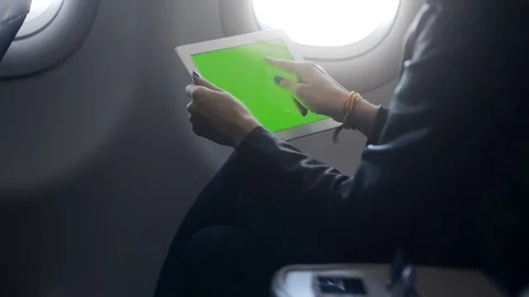 Woman using tablet in light bright airplane Stock Footage 103948664