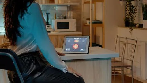 Woman using tablet in modern kitchen Stock Photos