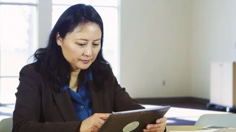 Woman using a tablet in an office Stock Footage 80260411