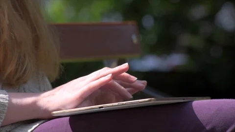 Woman Using Tablet In Park Stock Footage 90737194