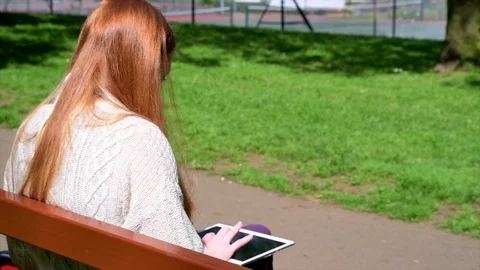 Woman Using Tablet In Park Stock Footage 90738141