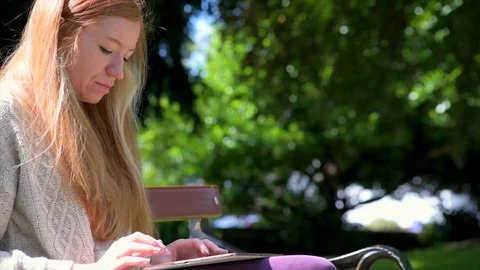 Woman Using Tablet In Park Stock Footage 90738547