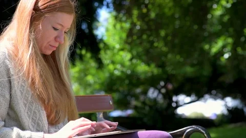 Woman Using Tablet In Park Stock Footage 90738698