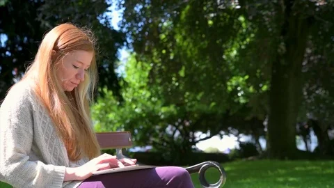 Woman Using Tablet In Park Stock Footage 90740045