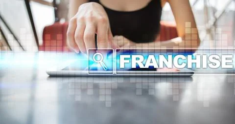 Woman using tablet pc and selecting franchise. 库存照片