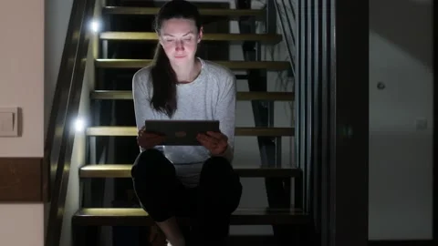 Woman using tablet pc at home at night Stock Footage 148108718