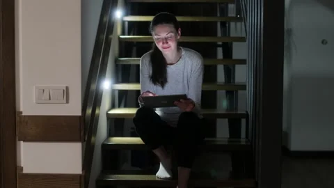 Woman using tablet pc at home at night Stock Footage 148108775