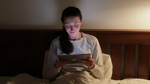 Woman using tablet pc at home at night Stock Footage 148108835
