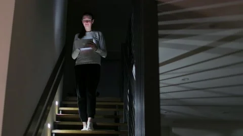 Woman using tablet pc at home at night Stock Footage 148109009
