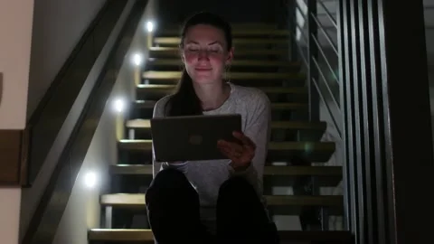 Woman using tablet pc at home at night Stock Footage 148109073