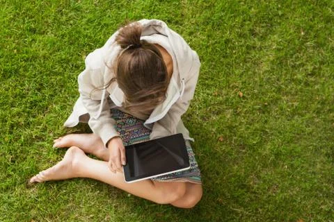 Woman using tablet PC at the park Stock Photos