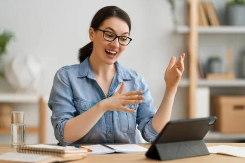 Woman is using tablet pc for remote conversation Stock Photos
