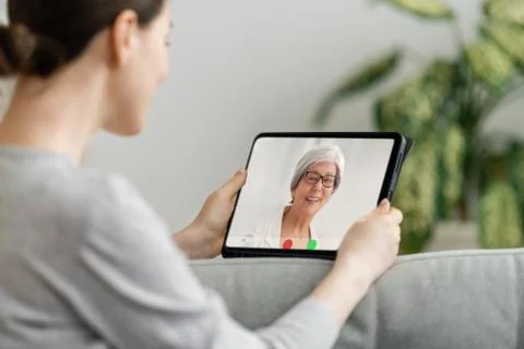 Woman is using tablet pc for remote conversation with friends Stock Photos