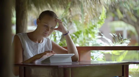 Woman using tablet PC sitting outdoor in tropics 스톡 동영상 45085565