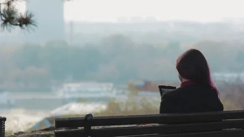 Woman using tablet pc sitting in the park Stock-Footage 69735242