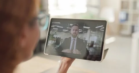 Woman Using Tablet for Remote Video Call With Businessman in Modern Office Stock-Footage 345168588
