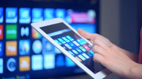 Woman using tablet with Smart TV Stock Footage 62916648