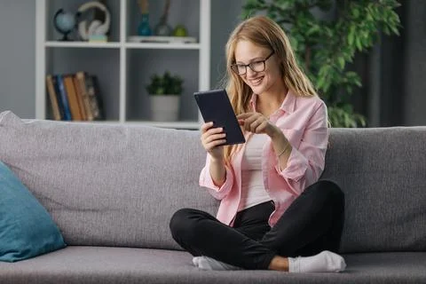 Woman using tablet on sofa Stock Photos