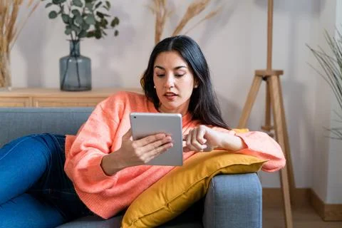 Woman using tablet on sofa Stock Photos