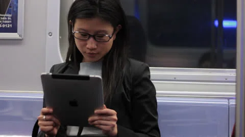 Woman Using Tablet on Subway Train Vidéo 22774249