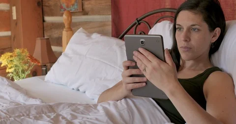 Woman using a tablet in a vertical position as if reading a digital book Video stock 107394107