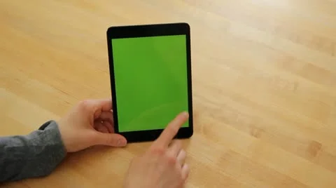 Woman Using Tablet on Wood Table Pan Right - Green Screen Stock Footage 22219033