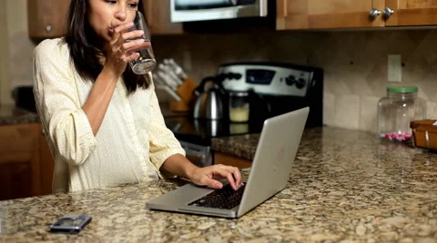 Woman using technology in kitchen Stock Footage 61665118