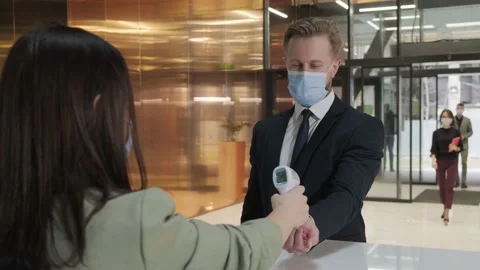 Woman using thermometer check temperature of office worker Stock Footage 152725676