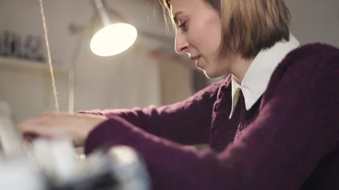 Woman using tool for pulling thread in weaving machine Stock Footage 87453543