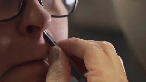 Woman using tool to remove nose hair in close-up personal grooming session Stock Footage 338265952