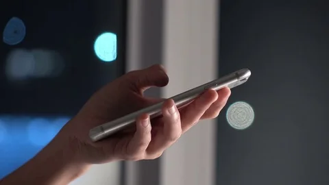 Woman using touch screen on smartphone with bokeh in city night background Stock Footage 74276015