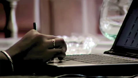 Woman using Touchpad to Scroll Data on Laptop while Sitting at Table at Night. Stock Footage 265344298