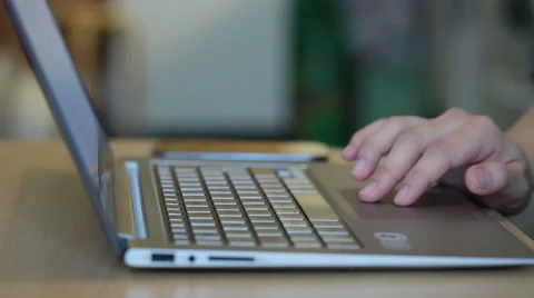 A woman using a touchpad to scroll on a laptop at home Video stock 42980030