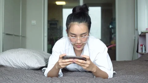 Woman using the touchscreen technology for play game or shopping online Stock Footage 90267932