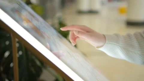 Woman using touchscreen terminal in mall. Detail view outstretched female hand Stock Footage 235164810