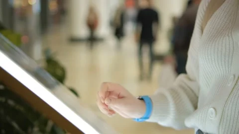 Woman using touchscreen terminal in mall. Detail view outstretched female hand Stock-Footage 235453531