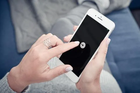 Woman using Uber app on Apple iPhone 8 plus Stock Photos