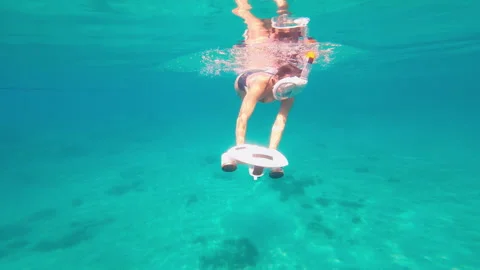 Woman using underwater scooter for diving. Modern sea scooter, modern technology Stock Footage 268624678
