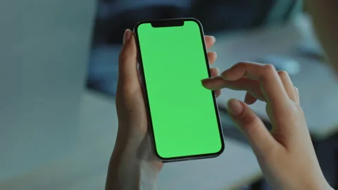 Woman using vertical smartphone with green screen. Female hands holding modern Stock Footage 213262192