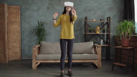 Woman using virtual reality glasses in the room Stock Footage 74958321