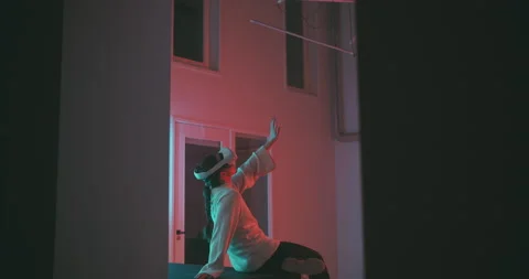 A woman using virtual reality glasses sitting on the table Stock Footage 201131554
